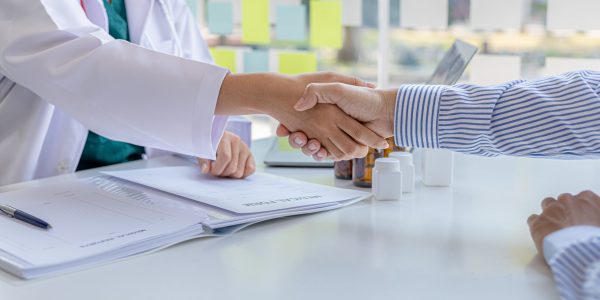 Doctor shook hands with the patient after informing the results of the examination and informing the patients about treatment guidelines and prescribing medicines. Disease examination concept.